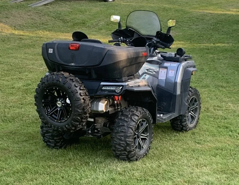 Spare tire mounted on the Tire Backpack carrier on the back of an ATV